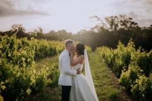 Bride and groom sharing a romantic moment in the vineyard at Beresford Estate wedding in Adelaide