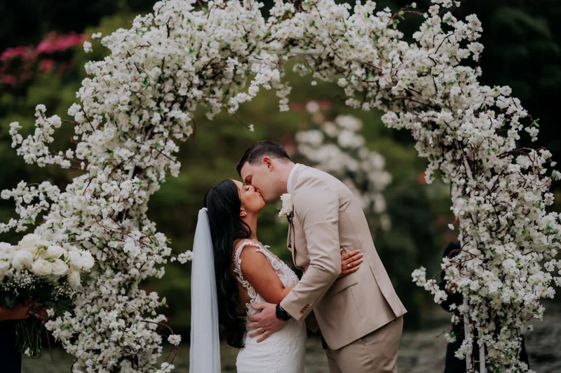 Bride and groom first kiss at the gardens at Illawarra Rhododendron Gardens during their Wollongong wedding