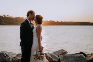 Bride Sophie and groom Jobe sharing a moment outside Scotts Head Surf Club during their Macksville wedding