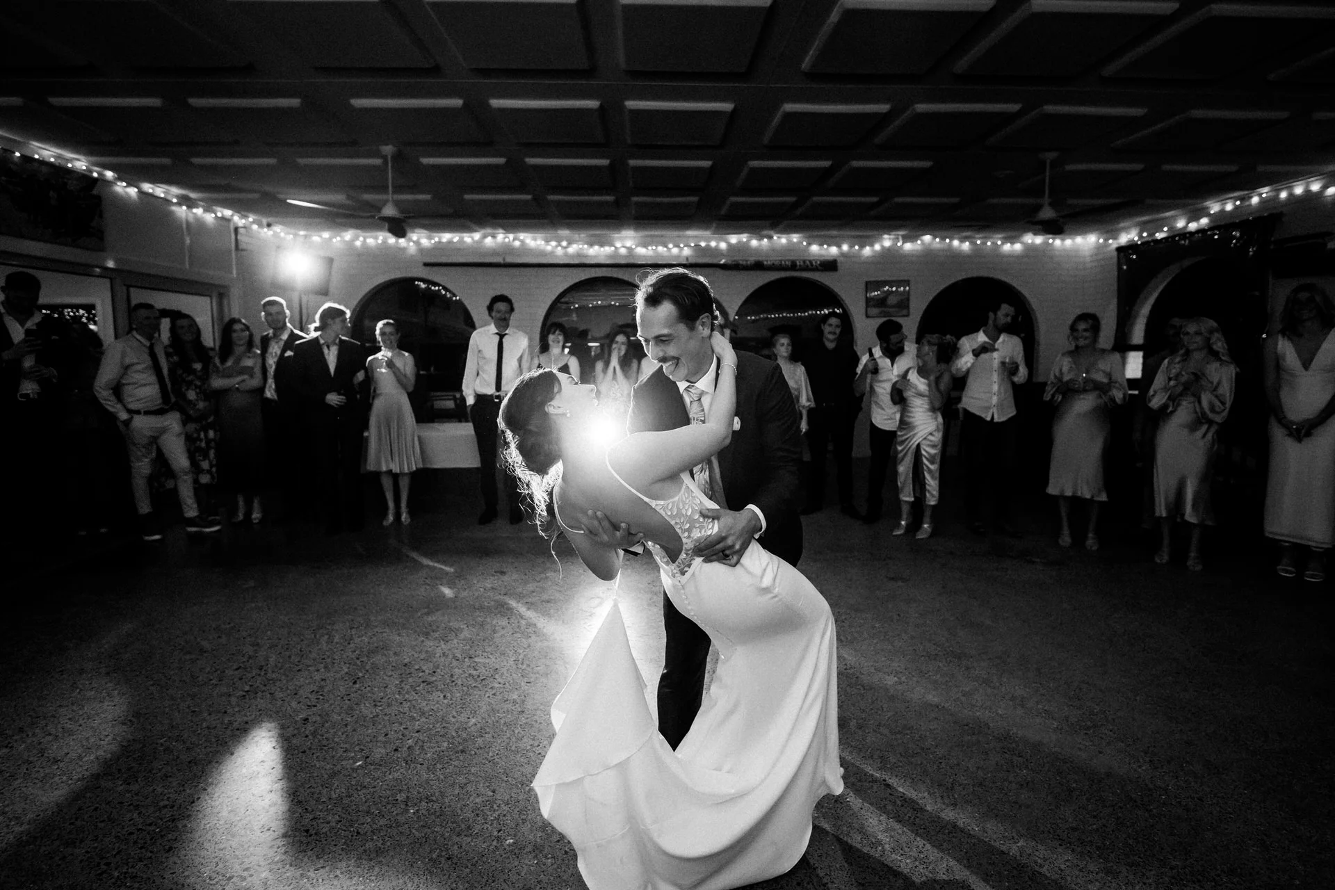 Bride Sophie and groom Jobe sharing a moment outside Scotts Head Surf Club during their Macksville wedding