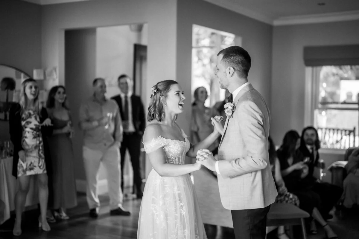 Bride and groom sharing their first dance under soft lighting during their backyard wedding in Wentworth Falls